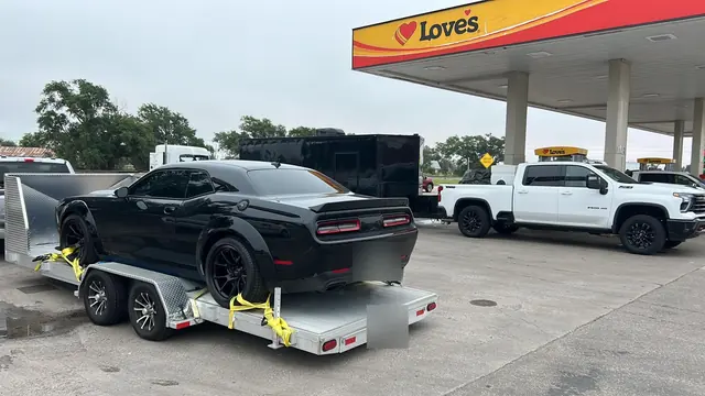 Dodge Challenger secured on the aluminum open car hauler