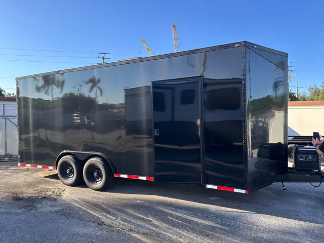 Enclosed car hauler side door and portable generator on the tongue