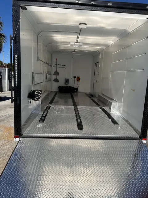 Interior of the enclosed car hauler seen from the rear ramp