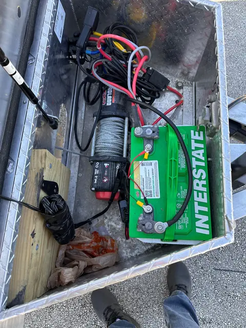 Electric winch and battery on the aluminum open car hauler