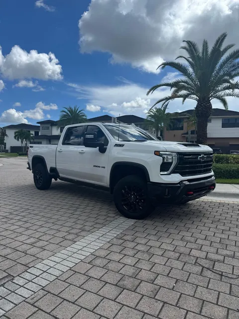 White 2025 Chevrolet Silverado 2500 HD LTZ Z71 diesel crew cab, front three-quarter view